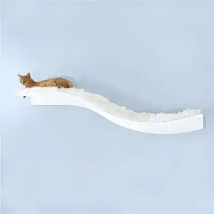 Ginger cat lounging on a curved, white wall-mounted shelf with fluffy cover against a light blue wall.
