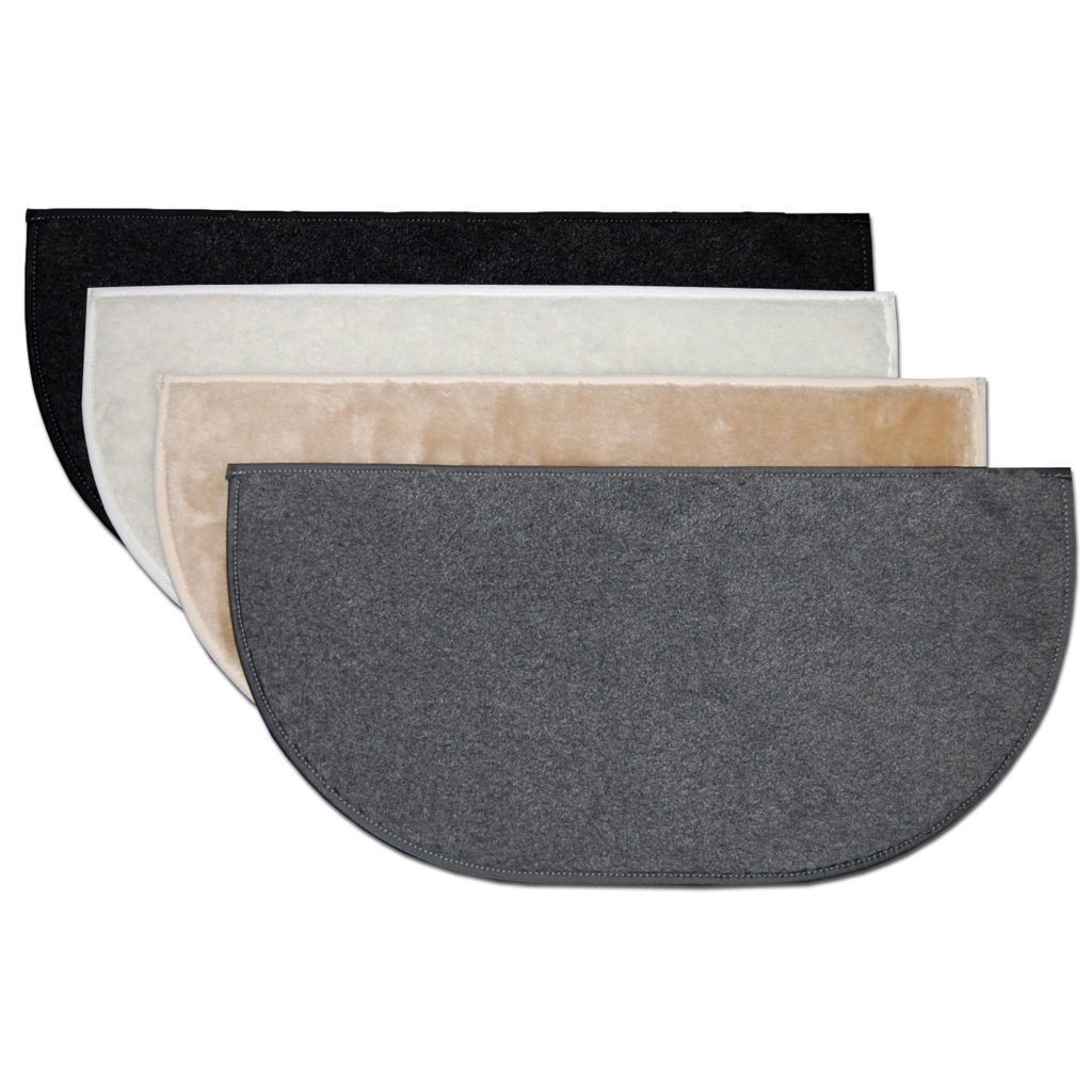 Four semi-circular doormats in black, white, beige, and gray overlap in a stack on a plain white background.