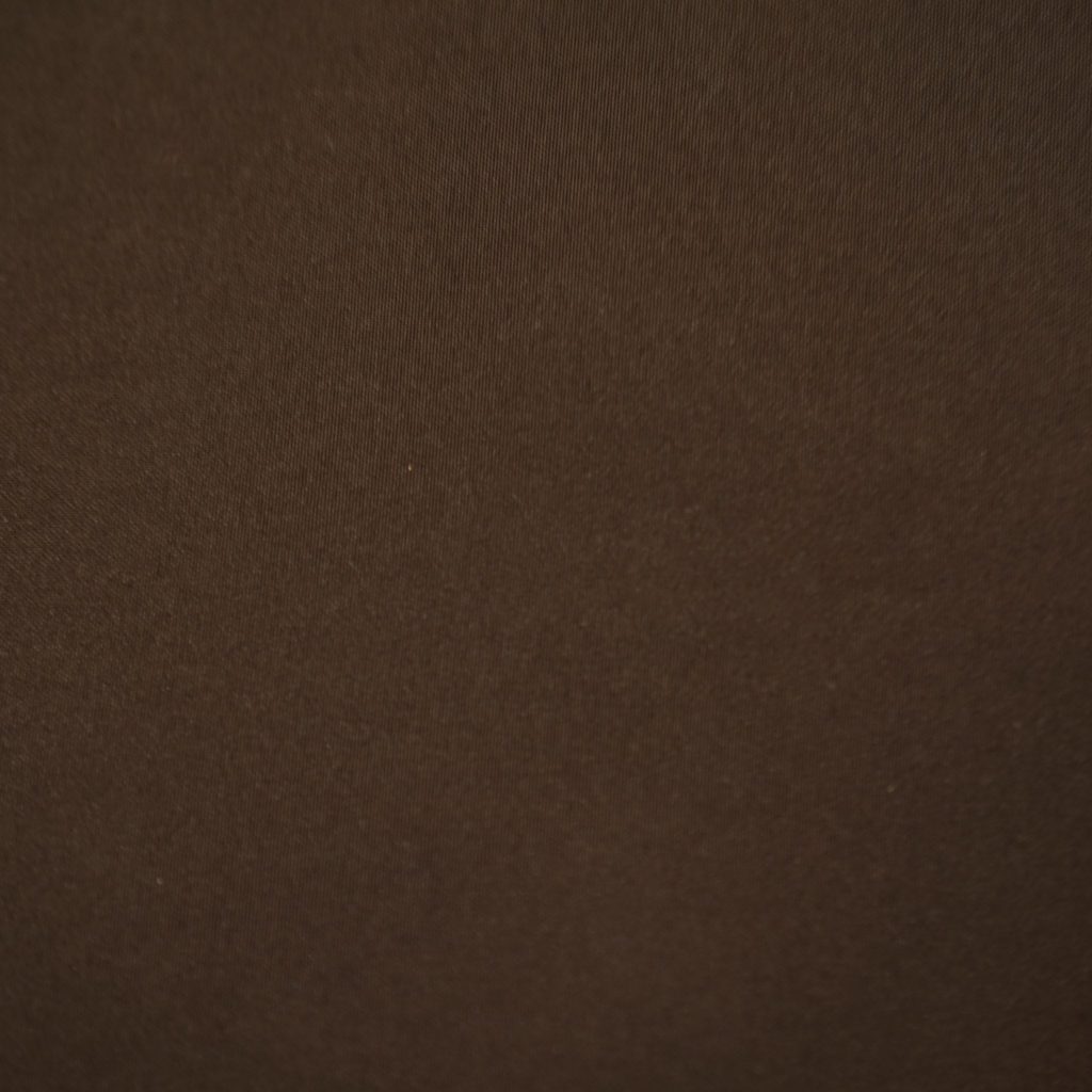 Close-up of LOT-CUS-ES, a smooth plain brown fabric often used in sleek, minimalist modern cat furniture.