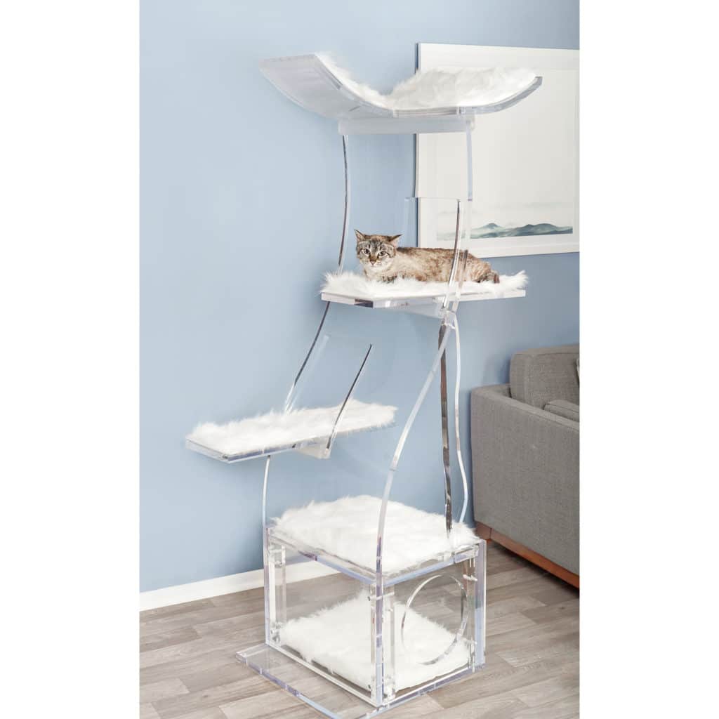 A transparent multi-level cat tree with white faux fur cushions in a living room; a cat rests on the middle platform.