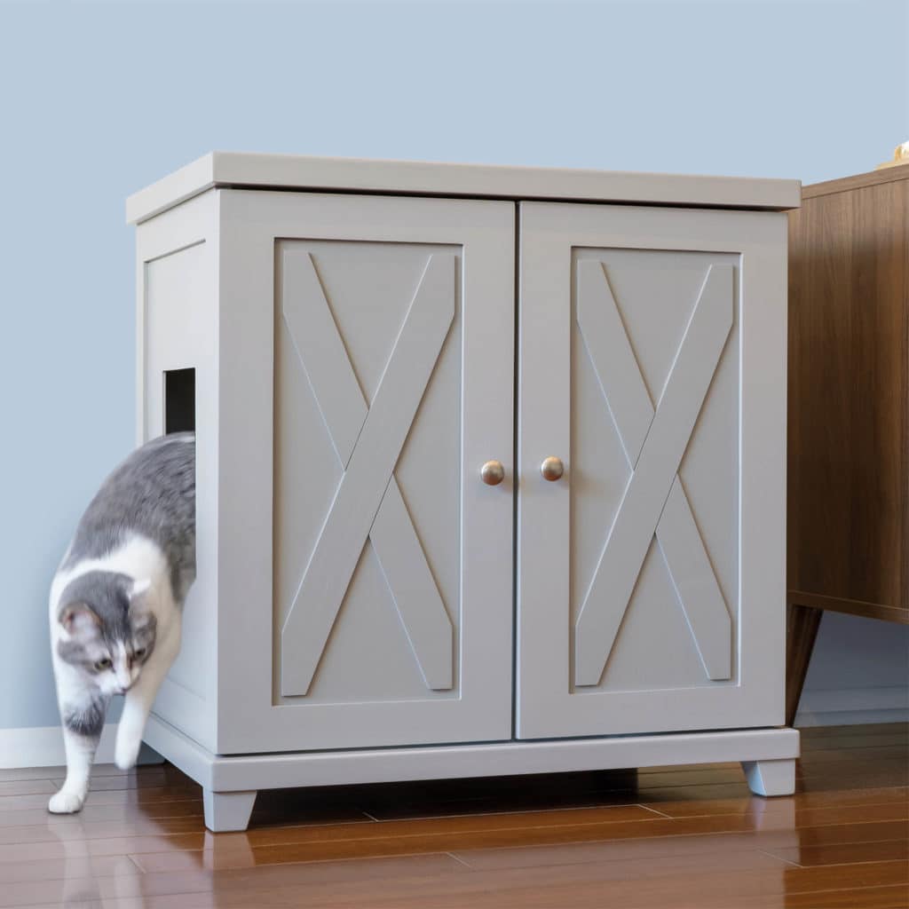 Gray and white cat leaves light gray cabinet with X-detailed double doors, on wooden floor.
