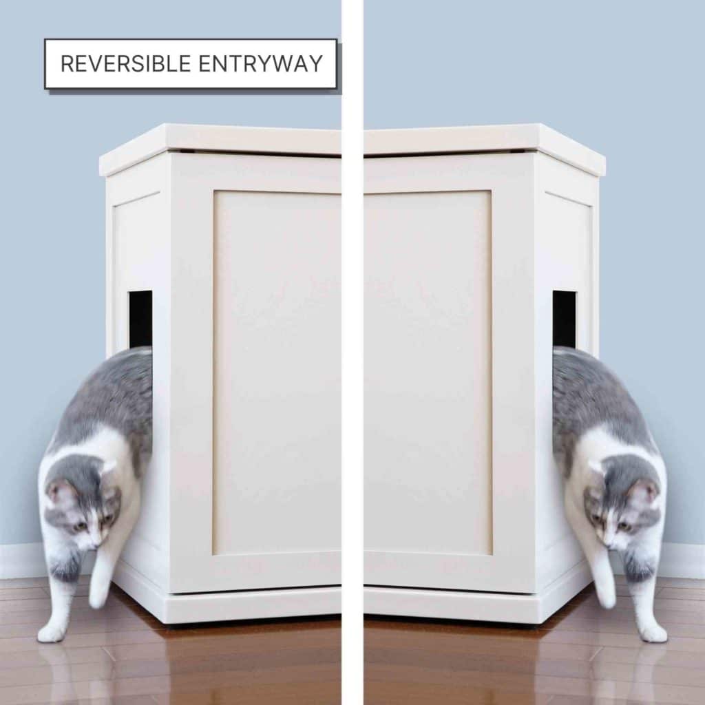 A gray and white cat walks out of a white Litter Box Cabinet with side doors on both the left and right.