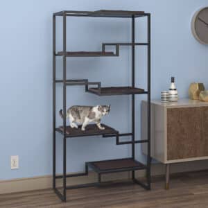 Cat on a black metal cat tower with brown cushion, in a minimalist room with light blue walls and mid-century decor.