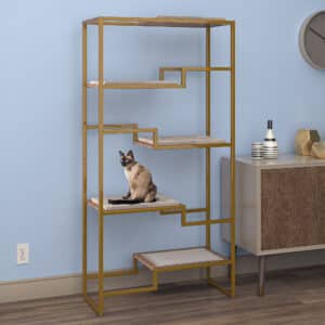 Cat on a modern gold condo with beige platforms, next to a wooden cabinet against a blue wall.