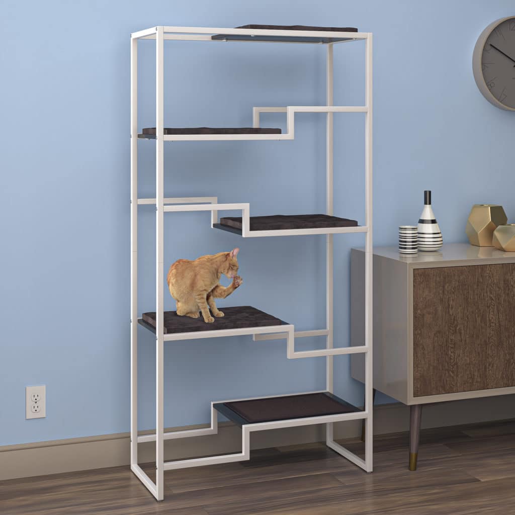 Cat standing on a multi-level metal shelf with white frame, black platform, and brown cushion by a blue wall and cabinet.