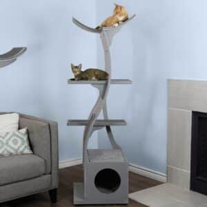 Two cats rest on separate levels of a LOT-SK-SQ-MD1 cat tower near a fireplace and gray sofa in a cozy living room.
