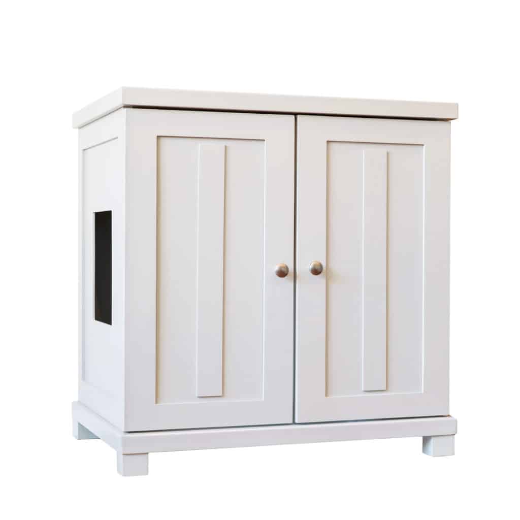 White wooden cabinet with paneled doors, round metal knobs, and a square cutout; designed as a modern cat litter box.