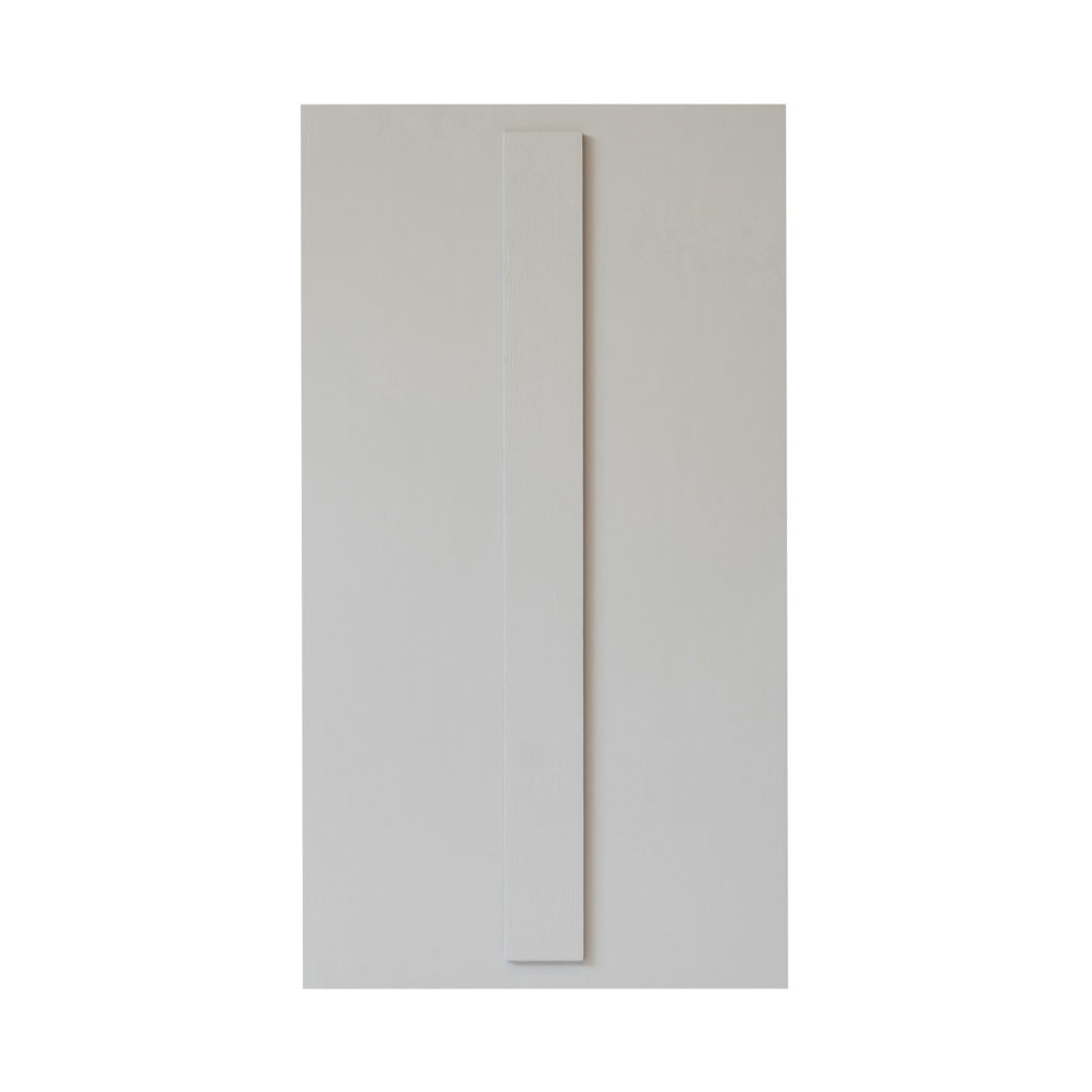 Tall, narrow white rectangle with smooth finish mounted vertically on a large plain white wall.