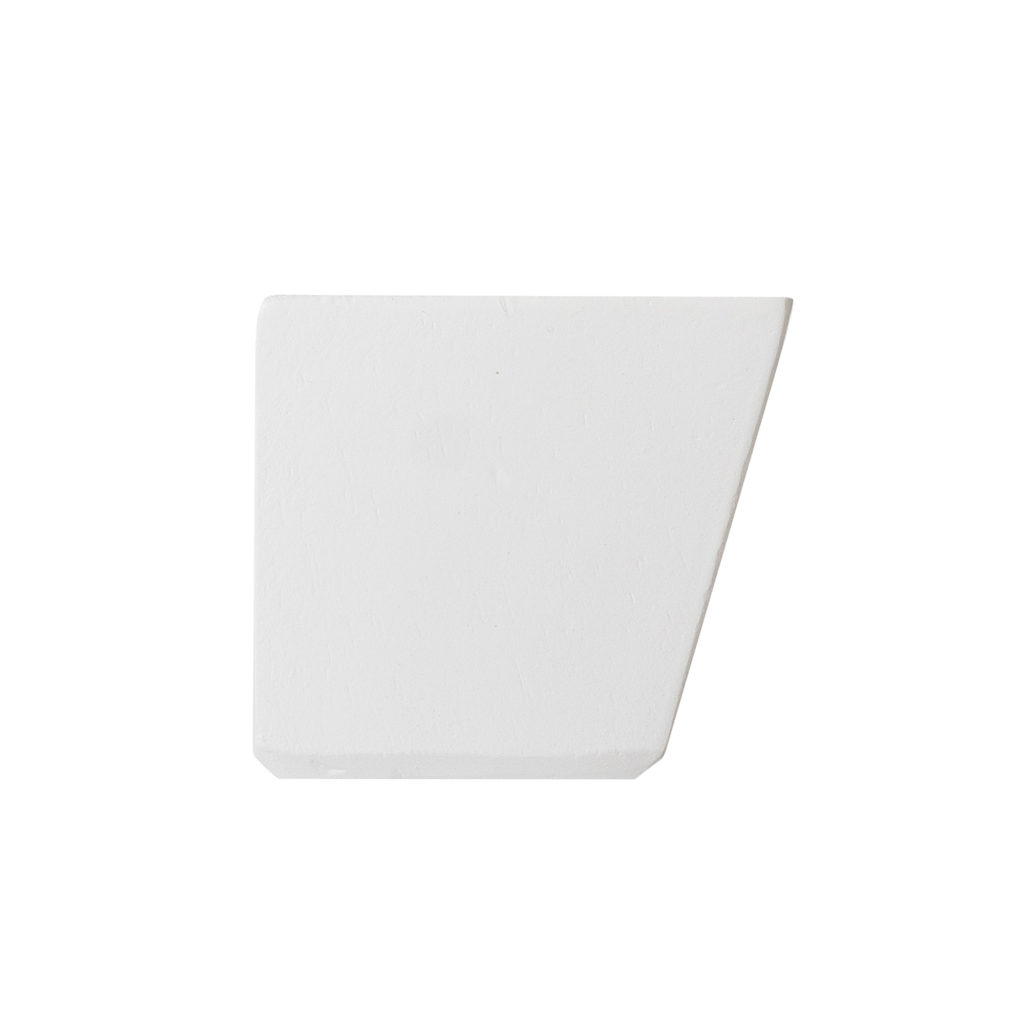 A white, wedge-shaped item with a straight left edge and angled right edge on a plain white background.