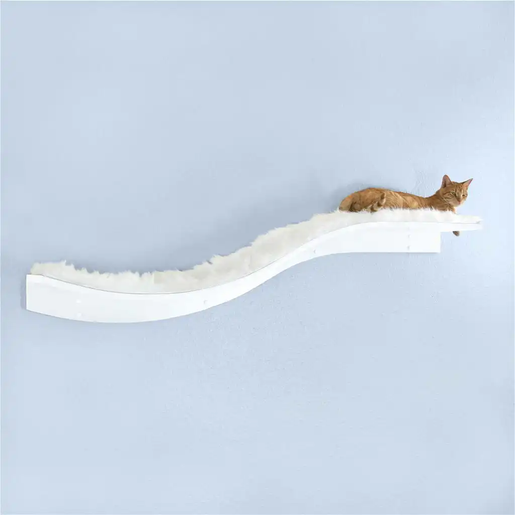 A cat resting on a white, fluffy Lotus Branch Cat Shelf mounted on a wall, with a light blue wall in the background.