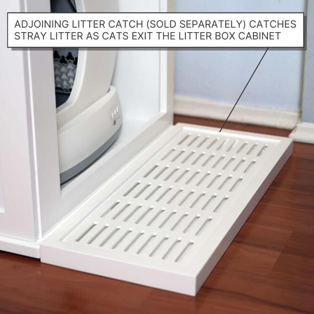 White slotted tray labeled "litter catch" sits next to a self-cleaning cat litter box on a wooden floor.