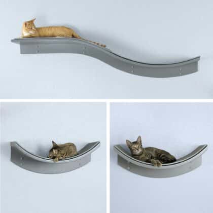 Three cats rest on individual curved gray Lotus-shelves, two facing the shelf branch, all mounted on a light-colored wall.