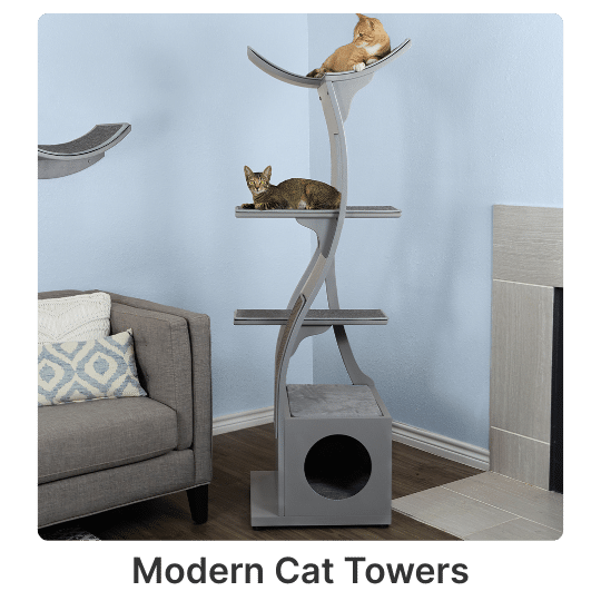 2 Two cats lounge on separate tiers of a gray cat tower near a gray couch and fireplace in a cozy living room.