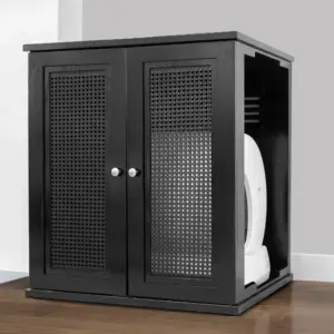 Black wooden litter box cabinet with mesh doors on a wooden floor, against a gray wall, concealing self-cleaning box.