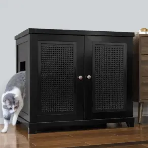 Black wooden cabinet with two lattice doors on hardwood floor; a cat steps out through a side opening.
