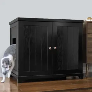Gray and white cat steps out of a side opening in a black wooden cabinet sitting on a hardwood floor.